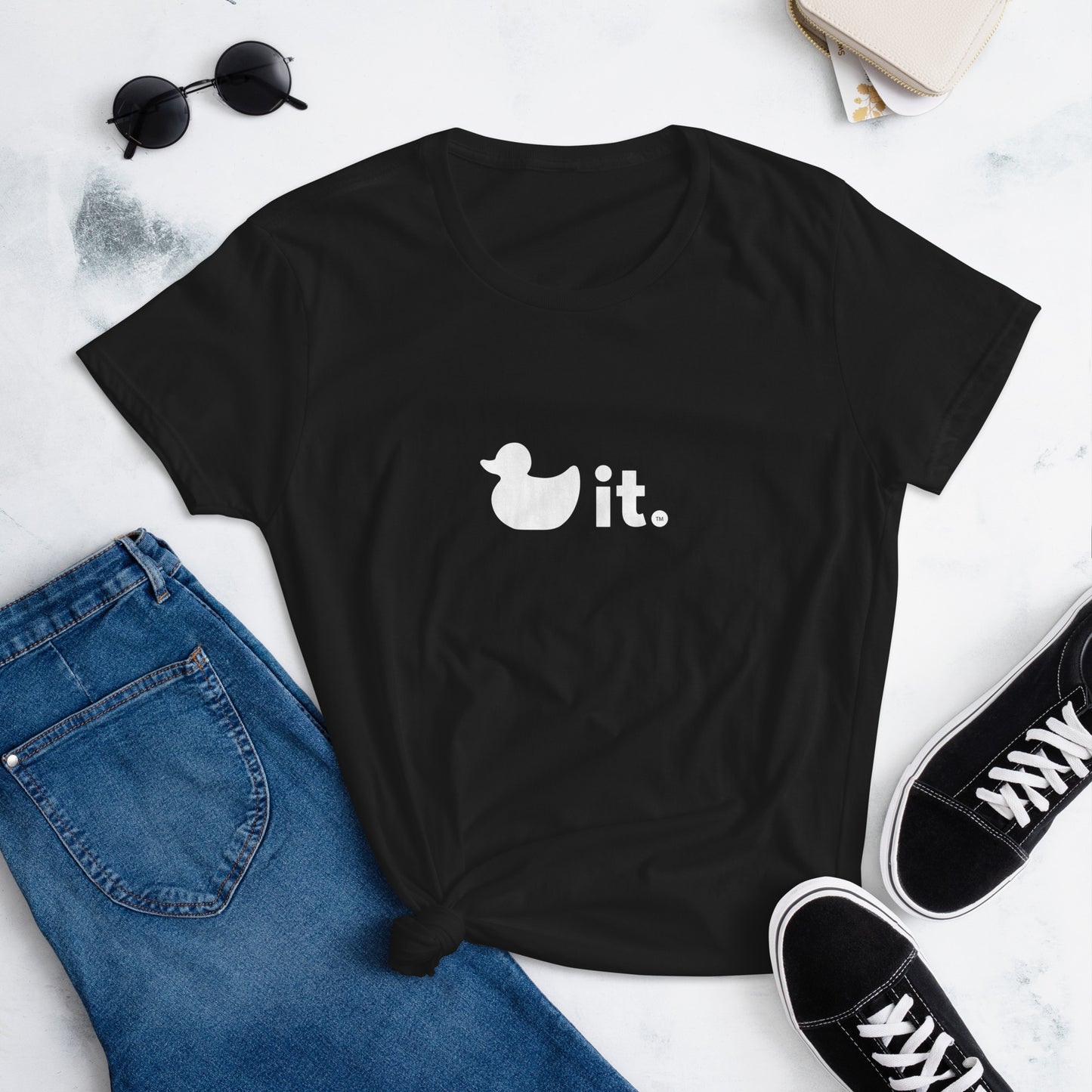 Black women's duck it logo shirt on table